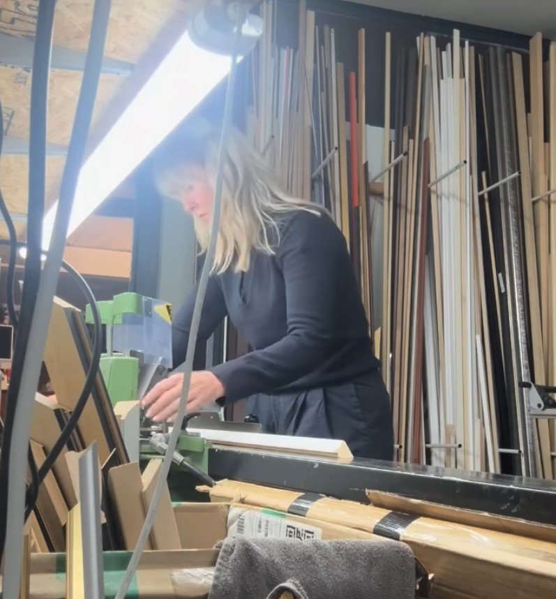 Cutting a frame moulding to size in the workshop